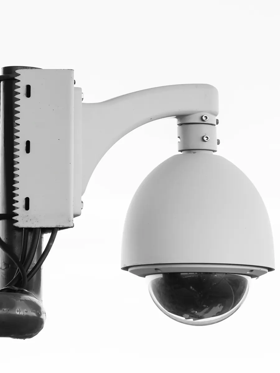 Pan-tilt-zoom dome camera on a pole bracket with a junction box