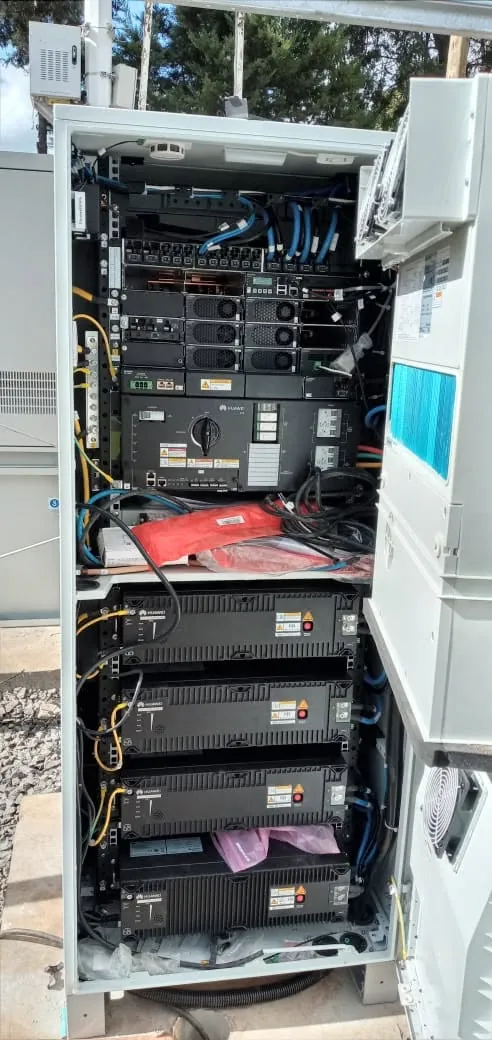 Open outdoor power cabinet showing battery modules and wiring